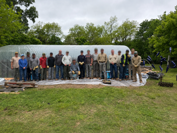 Community members and volunteers gather outdoors during The Tech Village's Build Day.